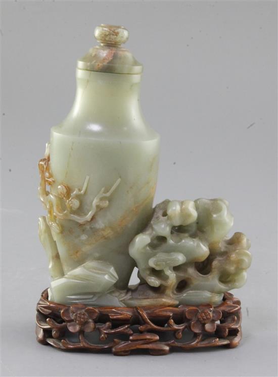 A Chinese celadon jade vase, 20th century, 17.5cm, together with a carved wood stand
